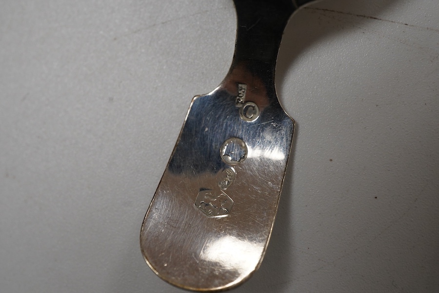 A George IV silver fiddle pattern caddy spoon, the bowl engraved with thistles, James Beebe, London, 1825, 90mm, a Georgian siler caddy spoon, the bowl embossed with urn and flowers, a late Victorian silver caddy spoon w